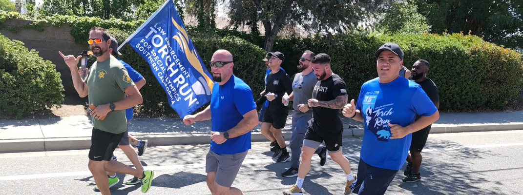 Policemen running at a charity event.