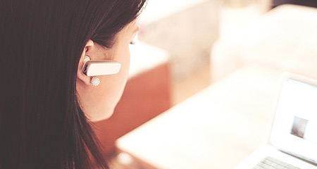 Woman with a headset at a customer service desk.